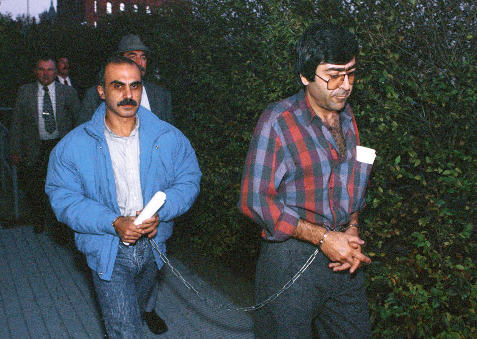 FILE - In this Oct. 28, 1987 file photo, two of three Canadians of Lebanese descent are led into federal court in Burlington, Vt. Walid Nicolas Kabbani, left, and Walid Mourad were caught with a third accomplice smuggling the makings of a bomb into the U.S., on Oct. 23, 1987, in Richford, Vt. All three were convicted and sent to federal prison. (AP Photo/Toby Talbot, File)