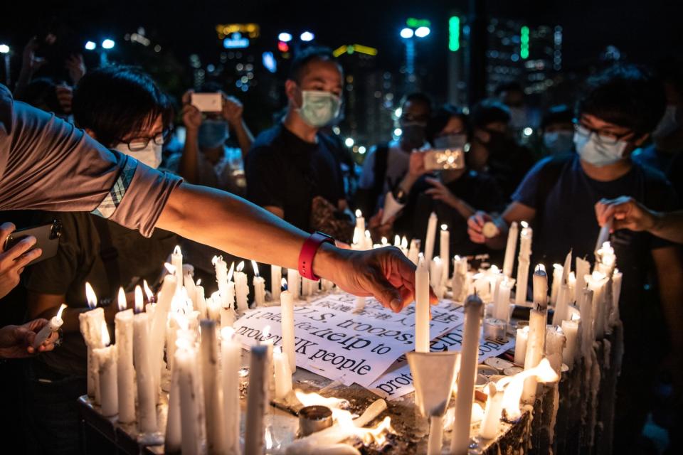 Candles surround a sign appealing to U.S. troops for help as Hong Kong marks Tiananmen Square anniversary.