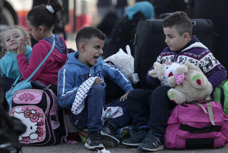 Palestians wait to enter Egypt from the Gaza Strip