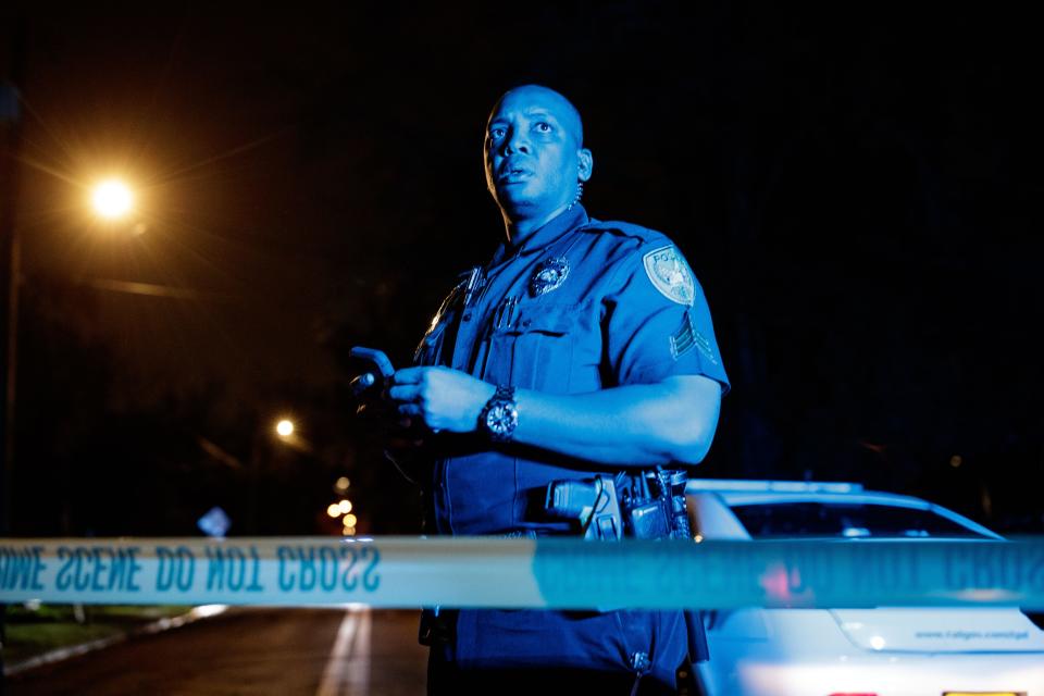 Tallahassee Police Department Sgt. Damon Miller looks up from his phone while leading an investigation after a shooting occurred on Keith Street in Tallahassee, Fla. on Wednesday, March 16, 2022.