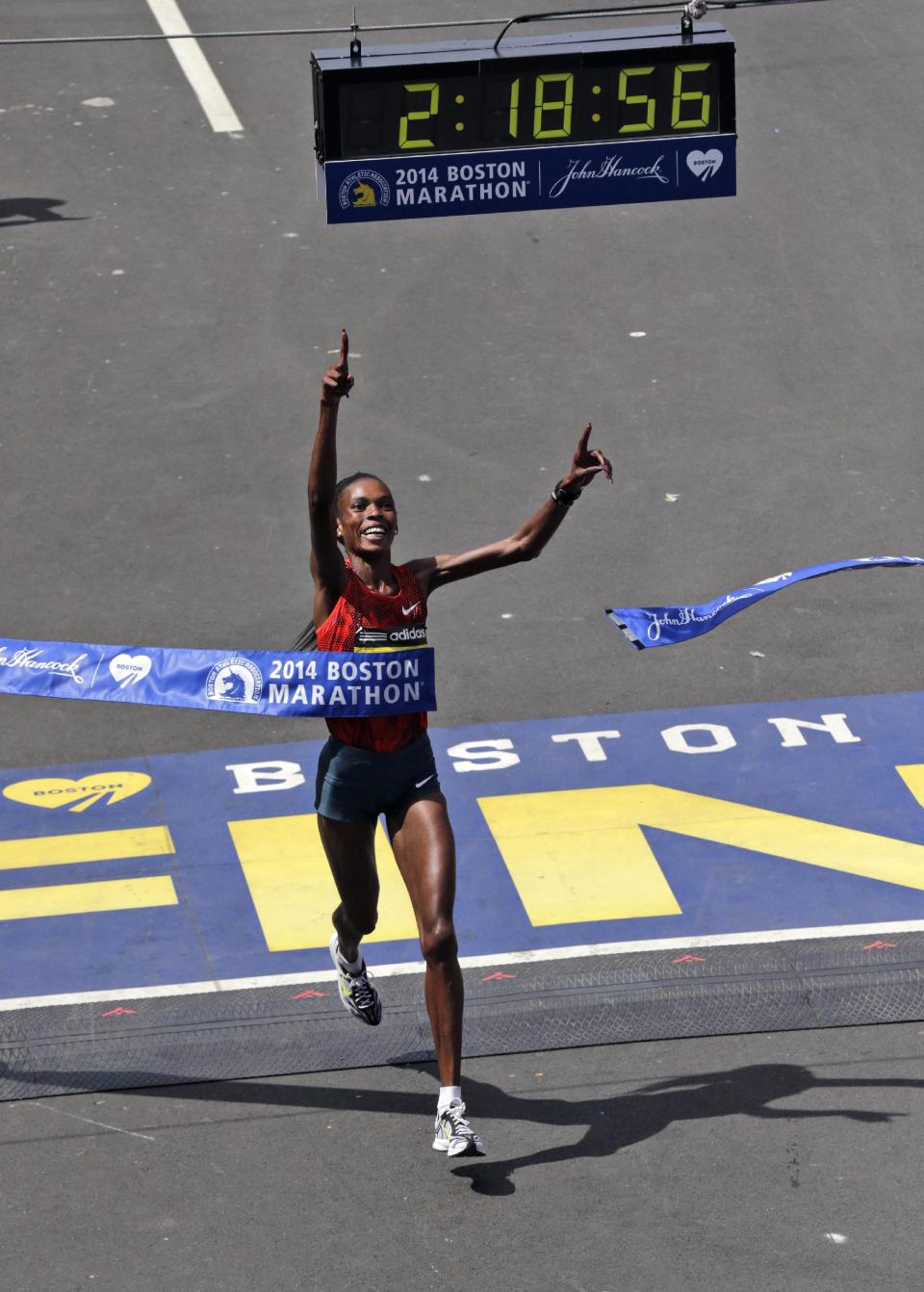 Rita Jeptoo, of Kenya, breaks the tape to win the women's division of the 118th Boston Marathon Monday, April 21, 2014 in Boston. (AP Photo/Charles Krupa)