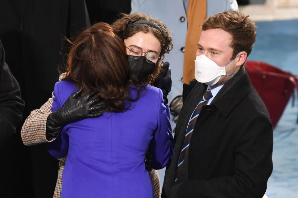 Vice President-Elect Kamala Harris (L) greets stepchildren Cole Emhoff and Ella Emhoff as she arrives for the inauguration of Joe Biden as the 46th US President on January 20, 2021, at the US Capitol in Washington, DC. (Photo by OLIVIER DOULIERY / AFP) (Photo by OLIVIER DOULIERY/AFP via Getty Images)