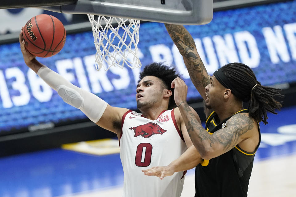 Arkansas' Justin Smith (0) drives against Missouri's Mitchell Smith, right, in the first half of an NCAA college basketball game in the Southeastern Conference Tournament Friday, March 12, 2021, in Nashville, Tenn. (AP Photo/Mark Humphrey)