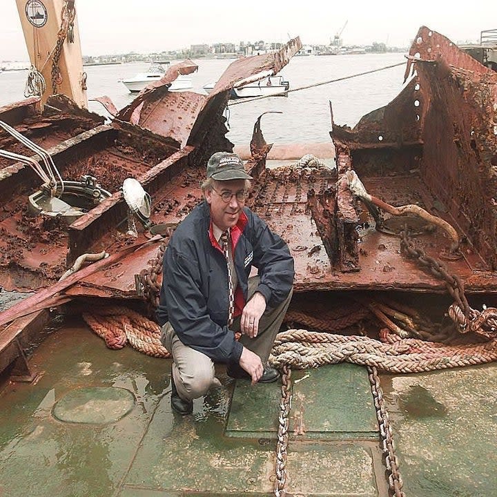 A man kneeling on a boat