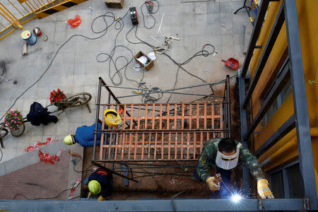 Workers weld a new facade to building of the former Sanyo factory in the Shekou area of Shenzhen, Guangdong Province, China, December 14, 2018. Picture taken December 14, 2018. REUTERS/Thomas Peter