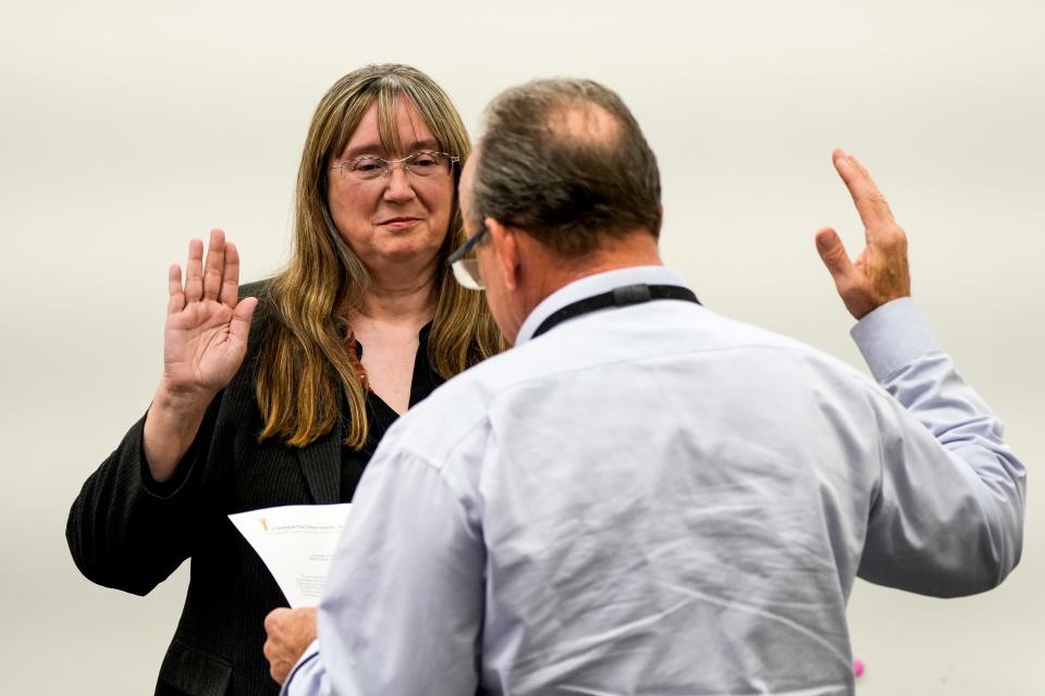 Linda Cecil was sworn in by Loveland City Schools' Interim Treasurer Robert Giuffre on Tuesday.