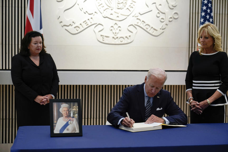 <p>President Joe Biden signs a condolence book at the British Embassy in Washington, Thursday, Sept. 8, 2022, for Queen Elizabeth II, Britain's longest-reigning monarch and a rock of stability across much of a turbulent century, who died Thursday after 70 years on the throne. She was 96. First lady Jill Biden, right, and British ambassador Karen Pierce, left, look on. (AP Photo/Susan Walsh)</p> 