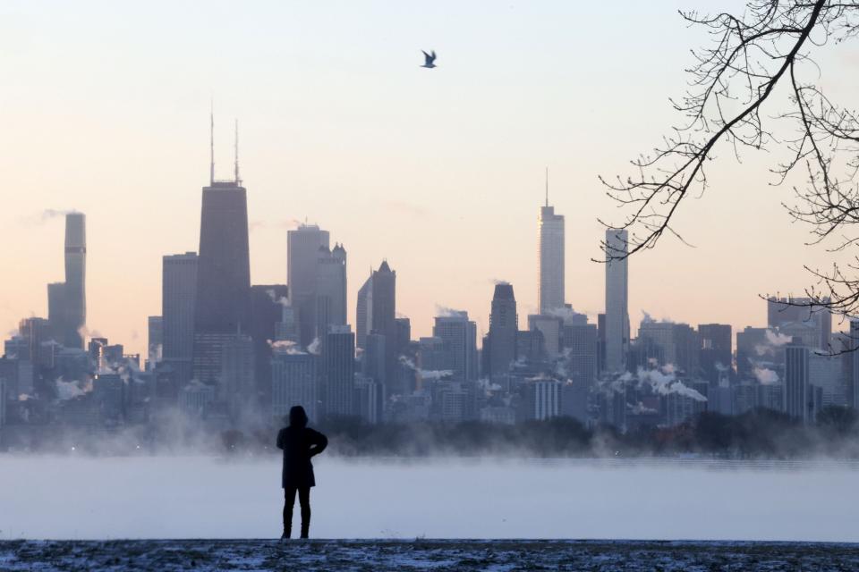 The sunrise shines over the Chicago skyline and the steaming frigid waters of Lake Michigan at Montrose Beach on Jan. 16, 2024