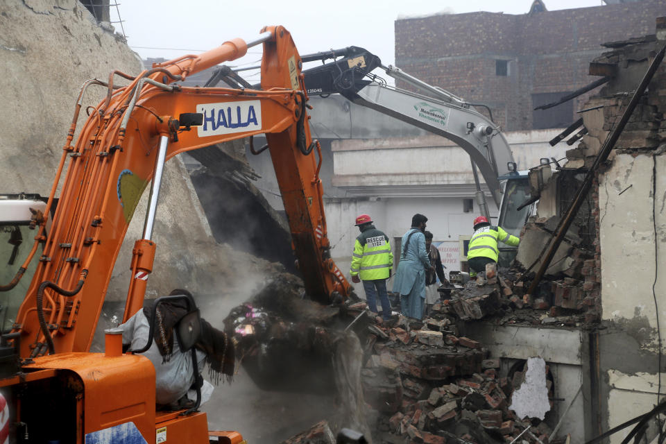 Pakistani rescue workers look for survivors amid debri of a building in Lahore, Pakistan, Tuesday, Jan. 28, 2020. Pakistani officials said Tuesday that a gas cylinder explosion at a small perfume-making factory killed many people and injured others. (AP Photo/K.M. Chaudhry)