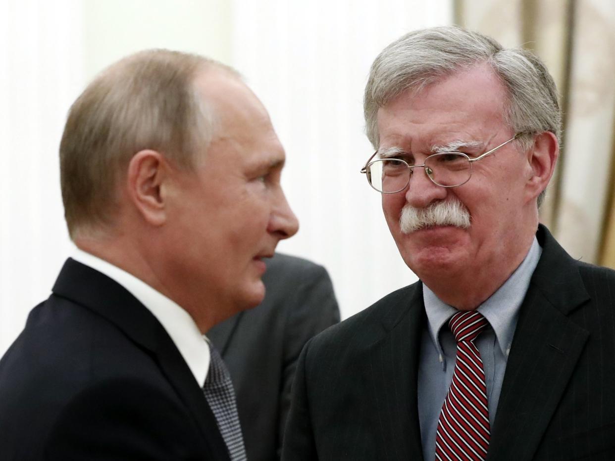 John Bolton, right, made the announcement after meeting President Putin at the Kremlin on Tuesday: AFP