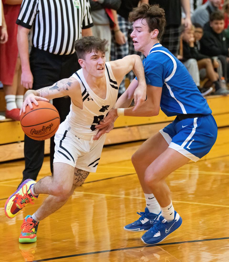 Perry’s Zander Sabin drives against Perry’s Anthony Maricocchi on Friday, Dec. 2, 2022.