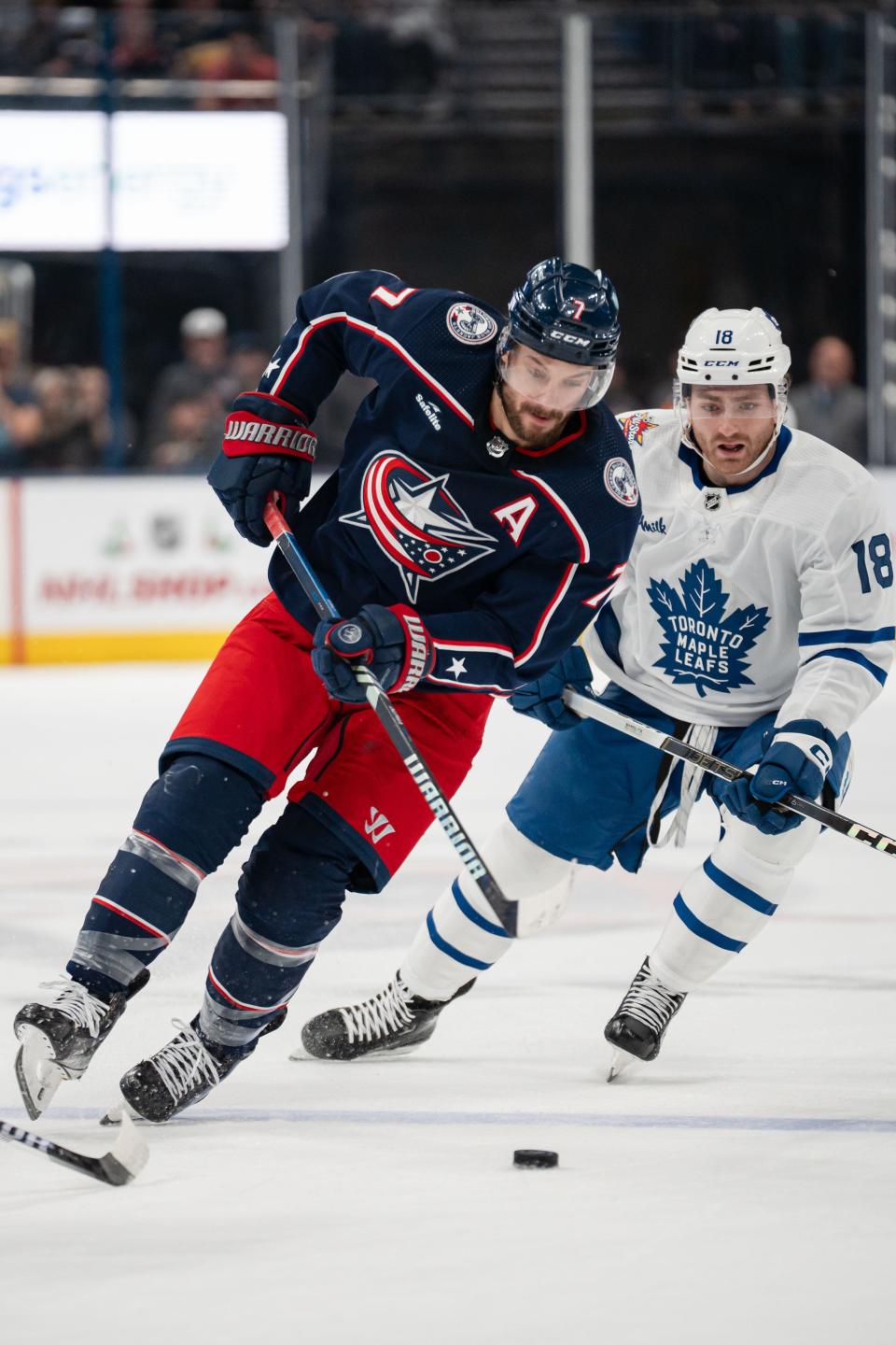 Dec 23, 2023; Columbus, Ohio, USA;
Columbus Blue Jackets center Sean Kuraly (7) brings the puck down the rink against Toronto Maple Leafs center Noah Gregor (18) during the first period of their game on Saturday, Dec. 23, 2023 at Nationwide Arena.