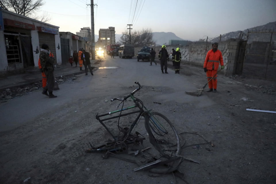 Afghan security personnel inspect the site of a bomb attack in Kabul, Afghanistan, Monday, Dec. 28, 2020. In two explosions Monday in the capital Kabul, multiple people were wounded, according to Kabul police. (AP Photo/Rahmat Gul)