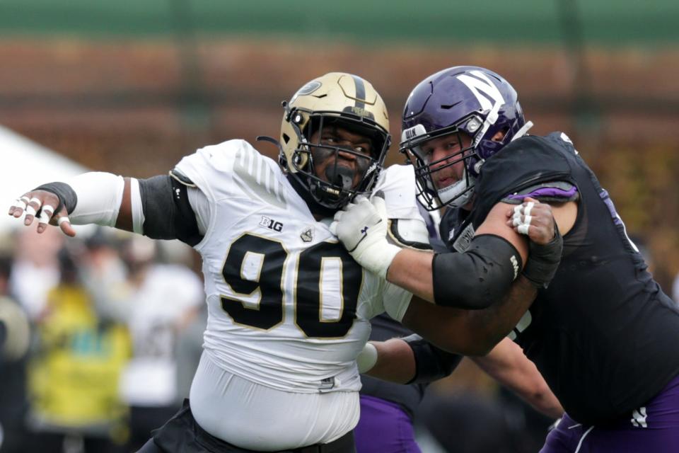 Northwestern offensive lineman Charlie Schmidt (69) blocks Purdue defensive tackle Lawrence Johnson (90) during the first quarter of an NCAA college football game, Saturday, Nov. 20, 2021 at Wrigley Field in Chicago.