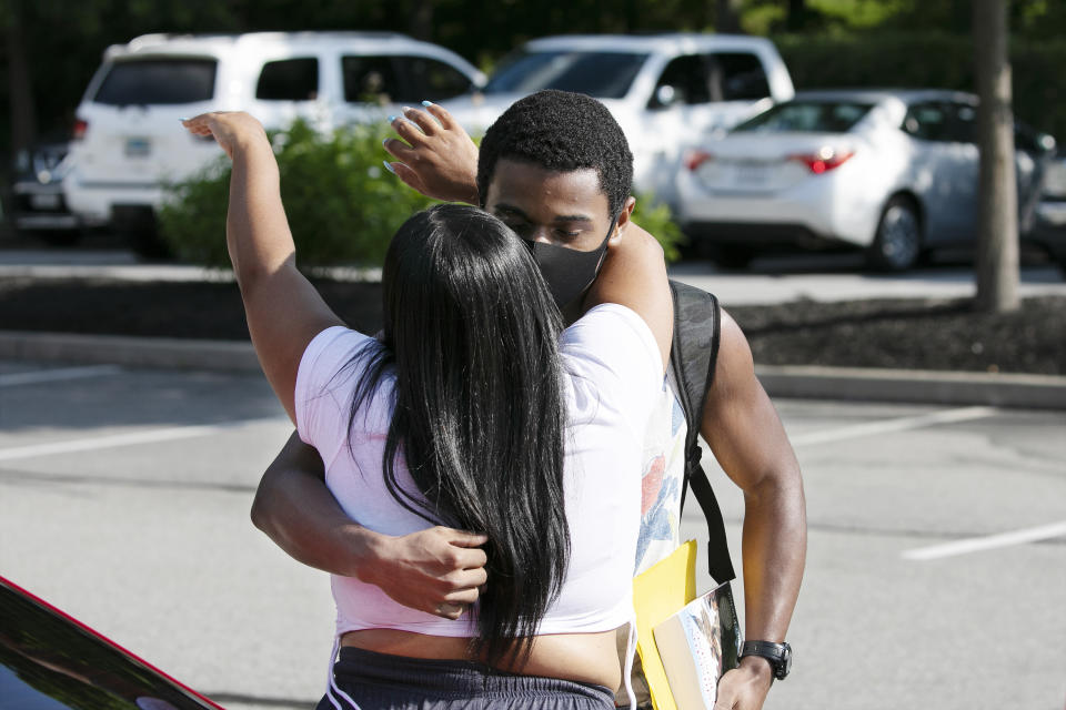 Cadet candidate Walter Thomas Pack, Jr., of Philadelphia, gets a goodbye hug from his mother Kathy as she drops him off at the U.S. Military Academy, Monday, July 13, 2020, in West Point, N.Y. The Army is welcoming more than 1,200 candidates from every state. Candidates will be COVID-19 tested immediately upon arrival, wear masks, and practice social distancing. (AP Photo/Mark Lennihan)