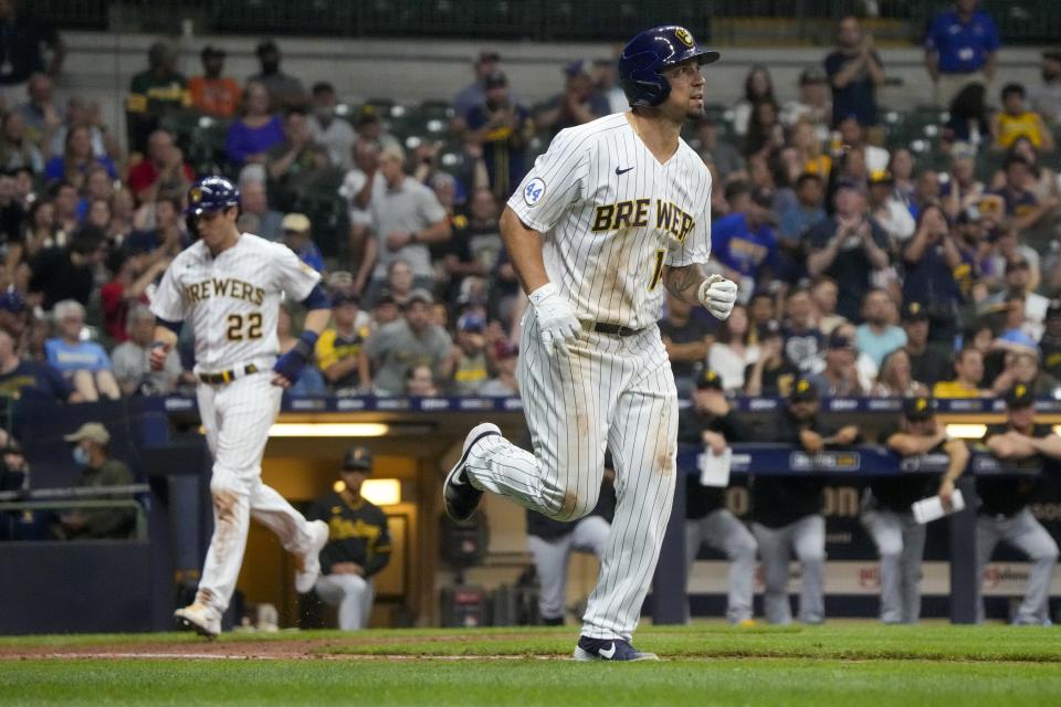 Milwaukee Brewers' Jace Peterson heads to first as Christian Yelich heads home after a walk with bases loaded during the seventh inning of a baseball game against the Pittsburgh Pirates Friday, June 11, 2021, in Milwaukee. (AP Photo/Morry Gash)