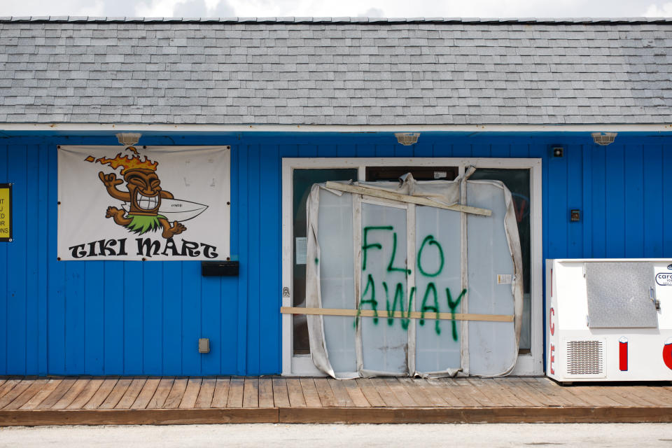 A Tiki bar sits empty with the message 'FLO AWAY' on Tuesday on Topsail Island, North Carolina.