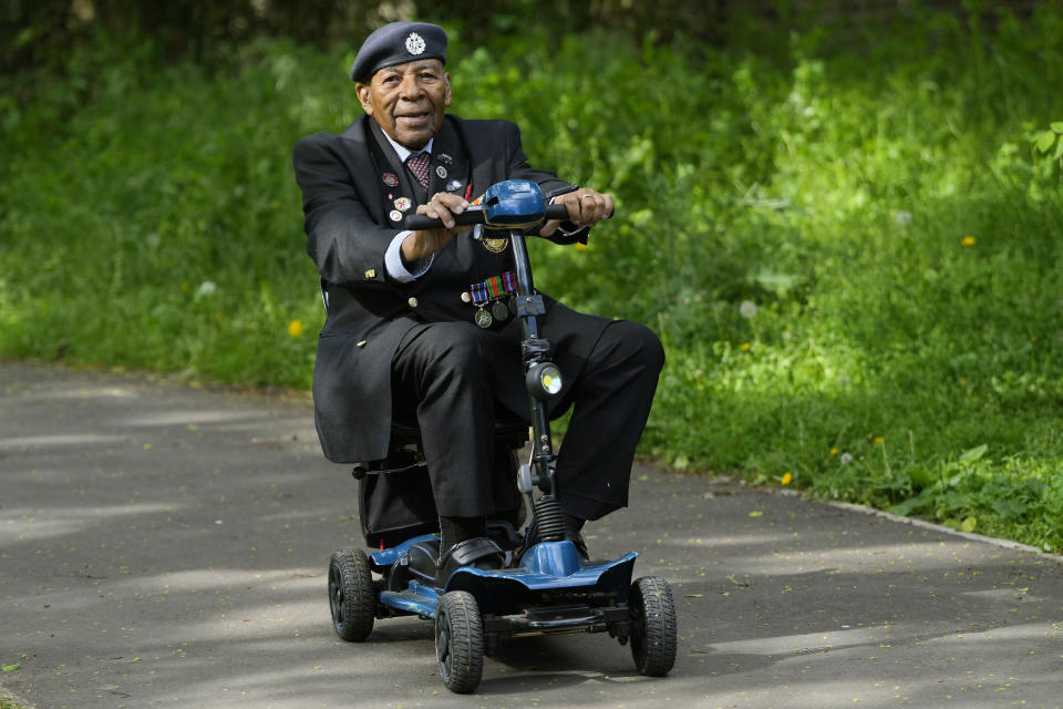 Gilbert Clarke a D-Day veteran rides his mobility scooter through the park near his home in east London, Wednesday, May 15, 2024. Clarke, now 98, is one of more than 3 million men and women from South Asia, Africa and the Caribbean who served in the British military during World War II. (AP Photo/Kirsty Wigglesworth)