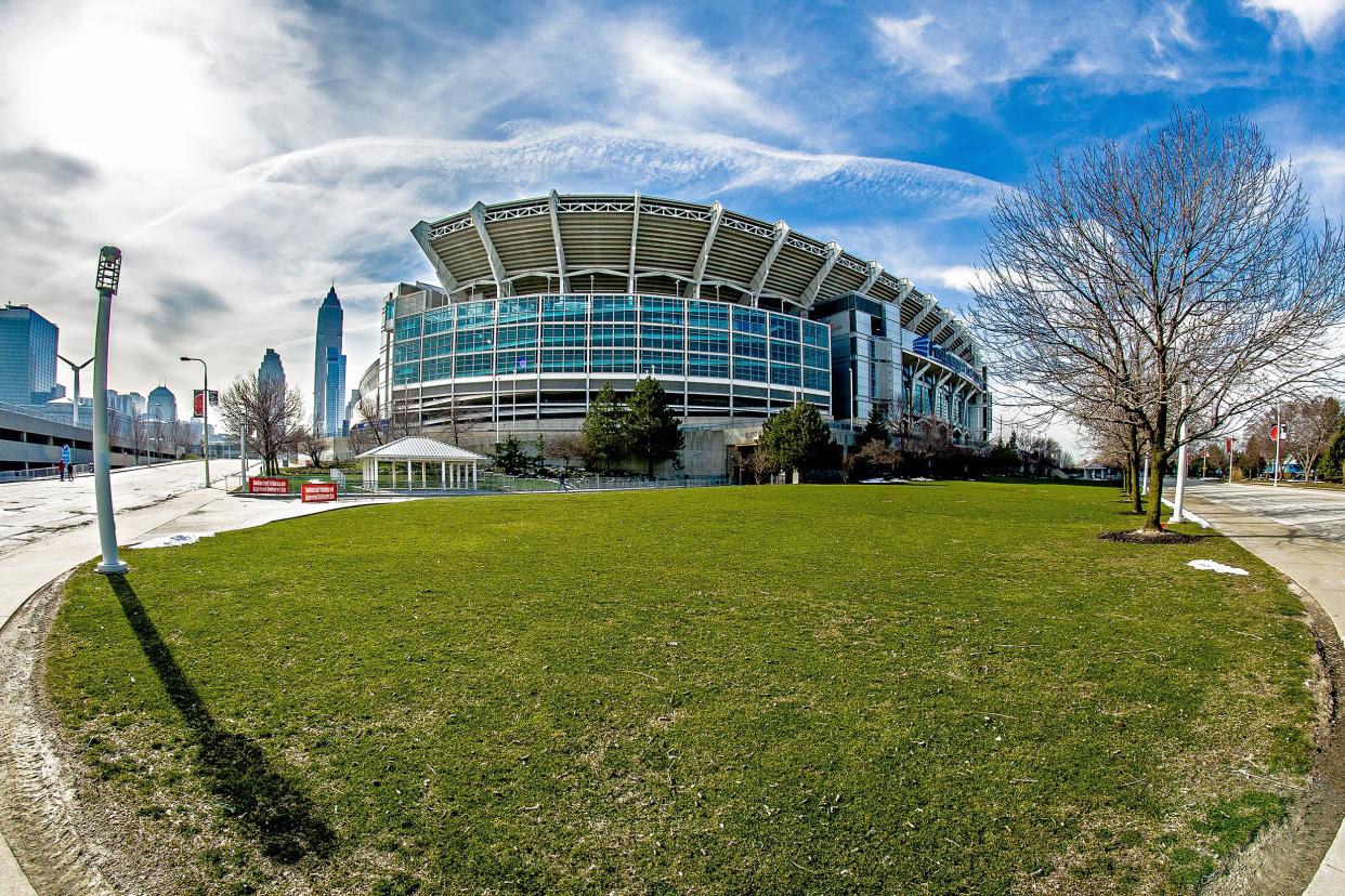 Cleveland Browns, FirstEnergy Stadium, Cleveland, fisheye lens view of exterior with grass in the foreground and against a dramatic blue sky with the sun and white clouds, on a sunny winter day with city in the background