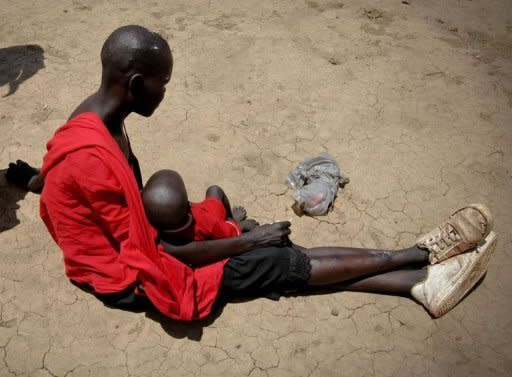 A Dinka Ngok woman and her baby, displaced by a military offensive by the northern Sudan Armed Forces on Abyei, arrive in Warrap State, southern Sudan after being evacuated by the UN on May 27. Fresh satellite images of Sudanâs flashpoint Abyei area provide evidence of war-crimes committed by the northern army, including "state-sponsored ethnic cleansing," a monitoring group said