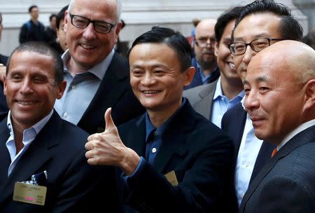 Alibaba Group Holding Ltd founder Jack Ma (C) gestures as he arrives at the New York Stock Exchange for his company's initial public offering (IPO) under the ticker "BABA" in New York September 19, 2014. REUTERS/Lucas Jackson