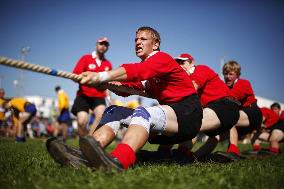 Team Switzerland compete in the 560 kg weight category during the Tug of War World Championships in the town of Appenzell, some 90 km (56 miles) east of Zurich September 8, 2012. The origin of tug of war is in ancient rituals and ceremonies, where the fight between the good and the bad was symbolized and later it developed into a sporting competition. REUTERS/Michael Buholzer (SWITZERLAND - Tags: SPORT SOCIETY)