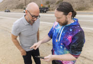 Author Neil Strauss, left, and Incubus guitarist Mike Einziger, of the podcast "To Live and Die in LA," appear on Thursday, June 17, 2021, in Malibu, Calif., at the location where the car belonging to Elaine Park was found. Park, who disappeared in 2017, is the subject of the second season of the podcast. (Photo by Willy Sanjuan/Invision/AP)