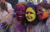 Surinamese girls pose for a picture as they celebrate the Hindu Festival of Holi, known as the Festival of Colors, in Paramaribo, March 17, 2014. Holi, of Indian origin, is a national public holiday in Suriname and is celebrated by people of different ethnic origins. REUTERS/Ranu Abhelakh (SURINAME - Tags: RELIGION SOCIETY)