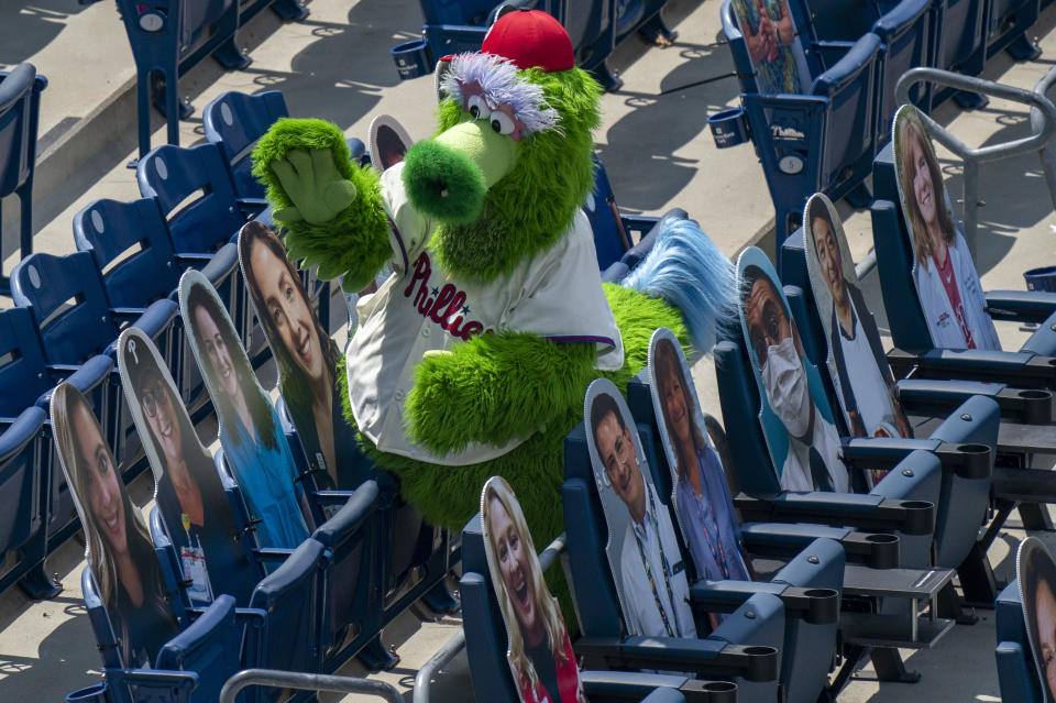 The Phillie Phanatic tries to interact with the cardboard cutouts of the fans in the stands during the third inning of a baseball game against the Miami Marlins, Sunday, July 26, 2020, in Philadelphia. (AP Photo/Chris Szagola)