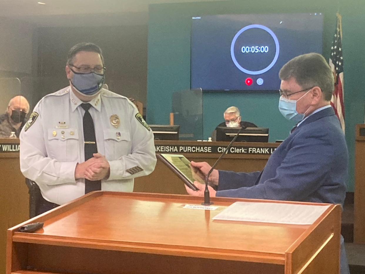 Springfield Mayor Jim Langfelder, right, recognizes Springfield Police Chief Kenny Winslow at the committee of the whole meeting at city council chamber Tuesday. Winslow is retiring Friday after 28 years with the department including almost nine years as chief, making him the longest-tenured police chief in city history.