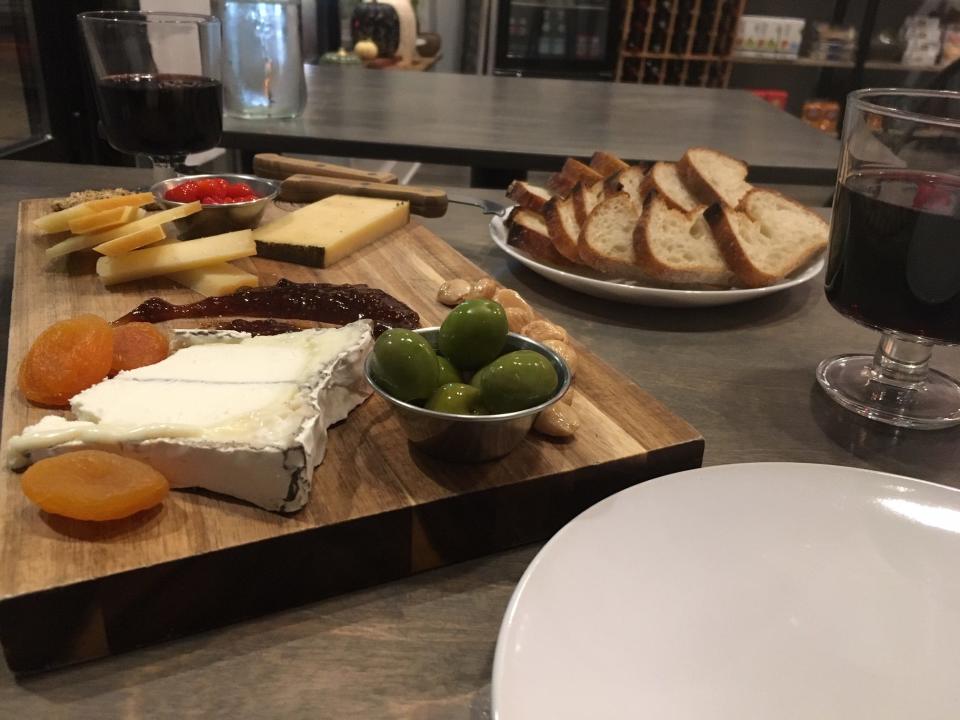 The bounty that is the 3 Cheese Combo board at Share: Cheesebar in Pleasant Ridge, accompanied by glasses of Rioja