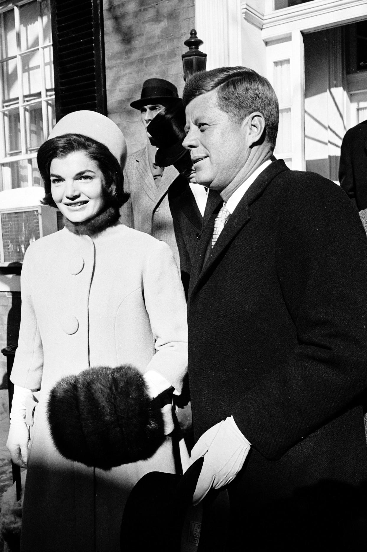 Jacqueline Kennedy, wearing one of the pillbox hats that became a signature look for her, poses for photos with husband John F. Kennedy as he prepared to be inaugurated in 1961. Washington had been buffeted by a heavy snowstorm the day before, but the sun shined brightly as he took the oath.