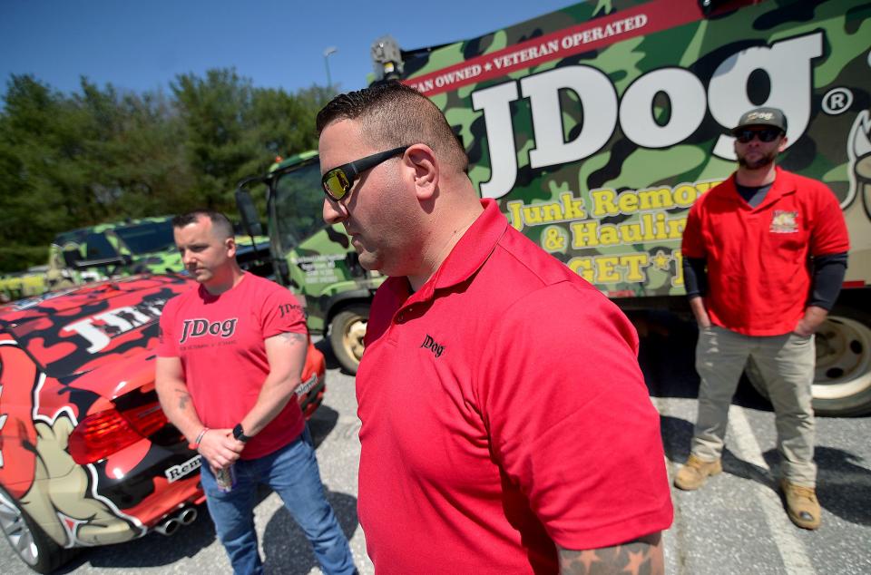 JDog franchise owner Aaron Mowery, center, of Hagerstown, helps with the JDog RED (Remember Everyone Deployed) campaign kick off  Thursday.