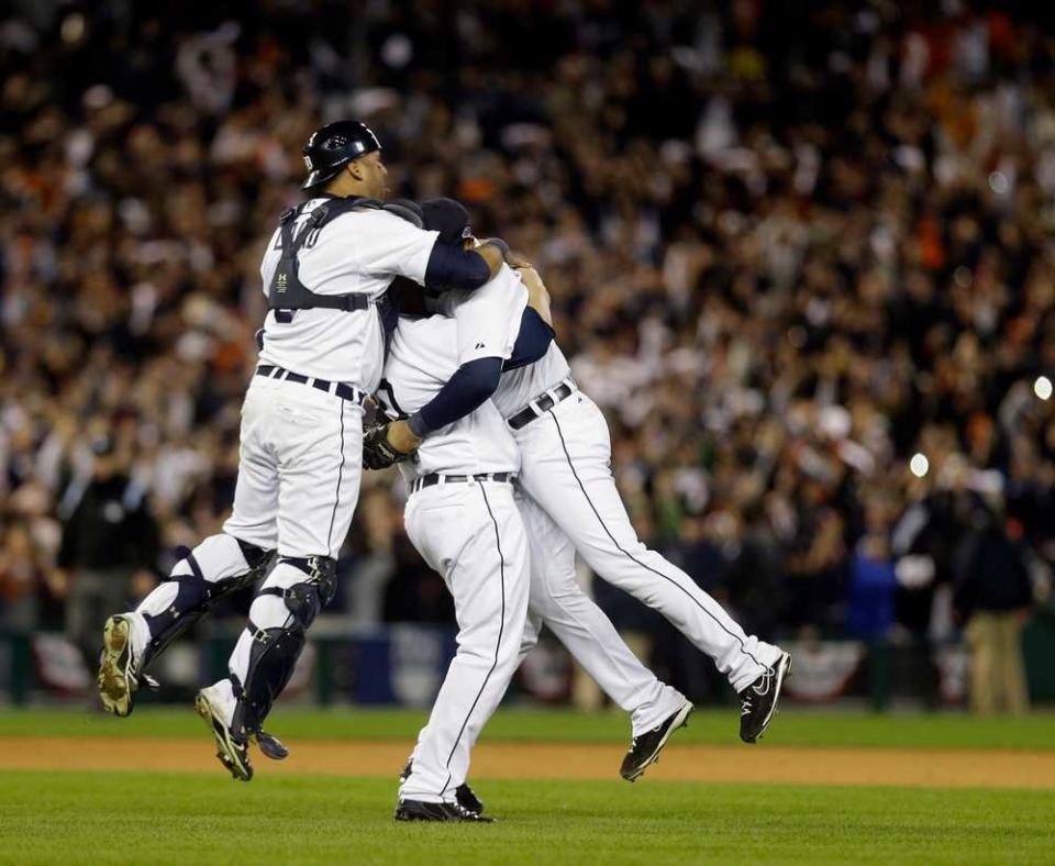 From left, Detroit Tigers' Gerald Laird, Phil Coke and Jhonny Peralta celebrate after winning Game 4 of the American League championship series 8-1, against the New York Yankees, Thursday, Oct. 18, 2012, in Detroit. The Tigers move on to the World Series. (AP Photo/Paul Sancya )