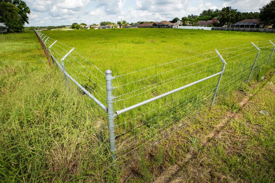 A fence surrounding property where HCA has proposed a hospital. The company plans to put a surgery center there.