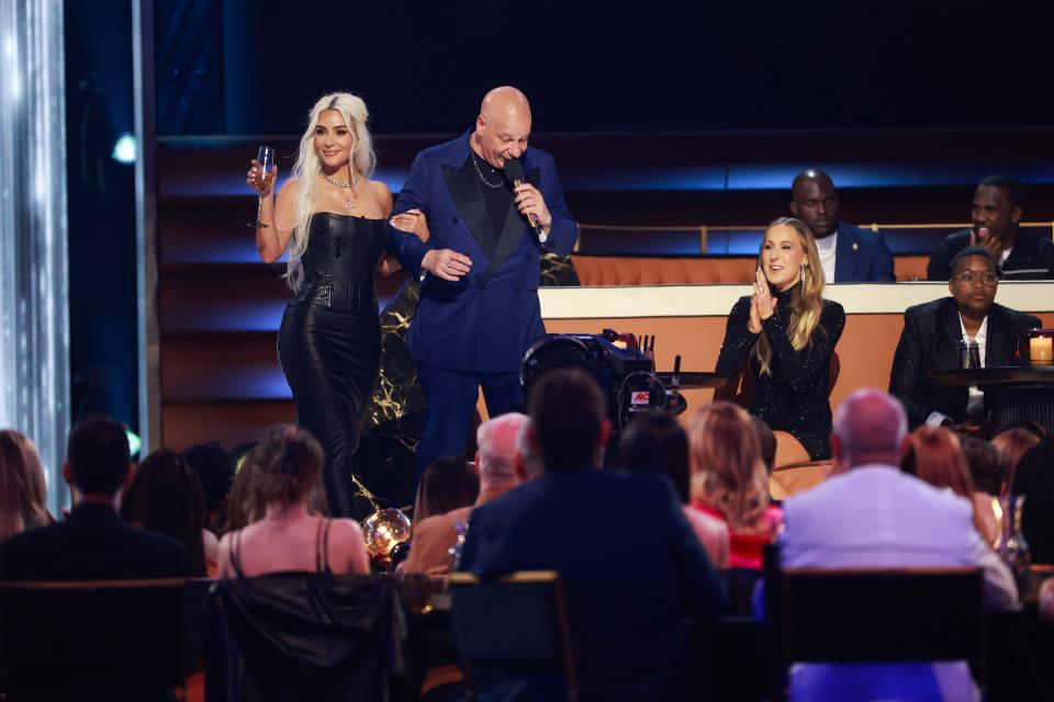Kim Kardashian, left, and Jeff Ross speak onstage during the "Greatest Roast Of All Time: Tom Brady" which aired on Netflix on May 5.