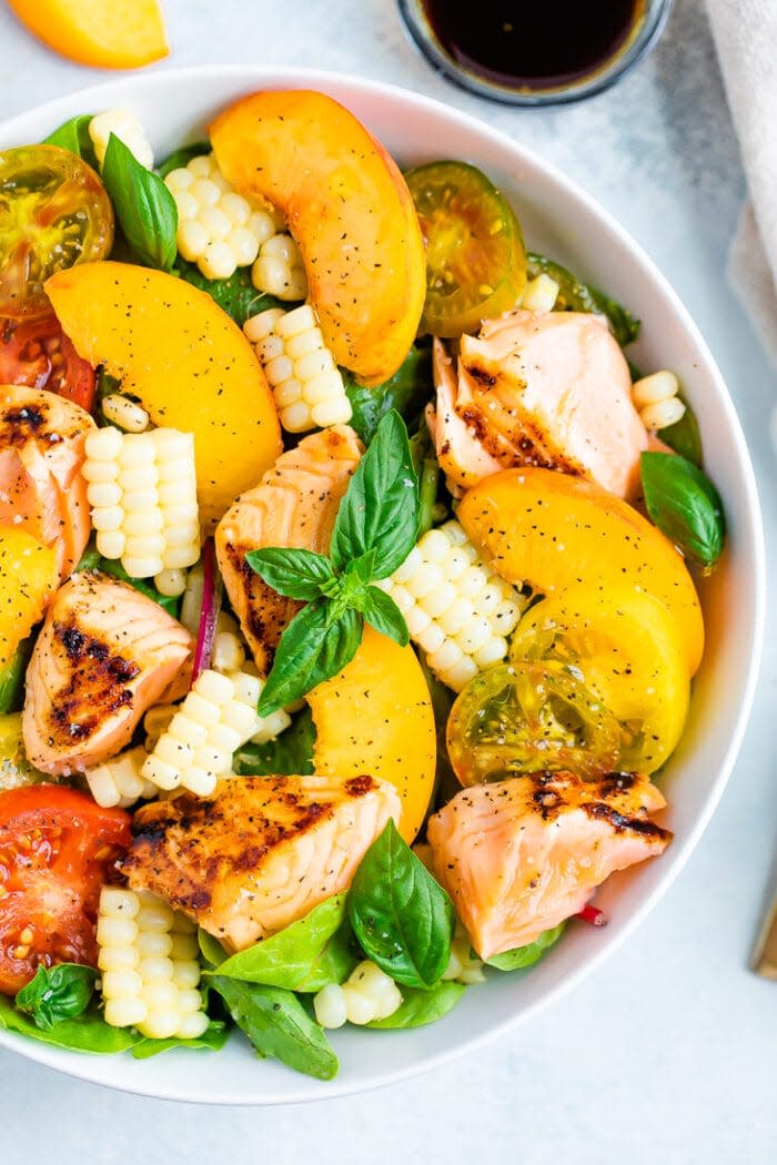 <p>Grilled fish. Sweet peaches. Juicy tomatoes. Crisp corn. This salad is just a bowl full of summer’s greatest hits.</p> <p>Get the recipe <a href="https://www.eatingbirdfood.com/grilled-salmon-summer-salad/" rel="nofollow noopener" target="_blank" data-ylk="slk:here;elm:context_link;itc:0;sec:content-canvas" class="link ">here</a>.</p>