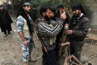 Rebel fighters inspect a mortar in the northeastern Syrian city of Deir Ezzor on December 31, 2013