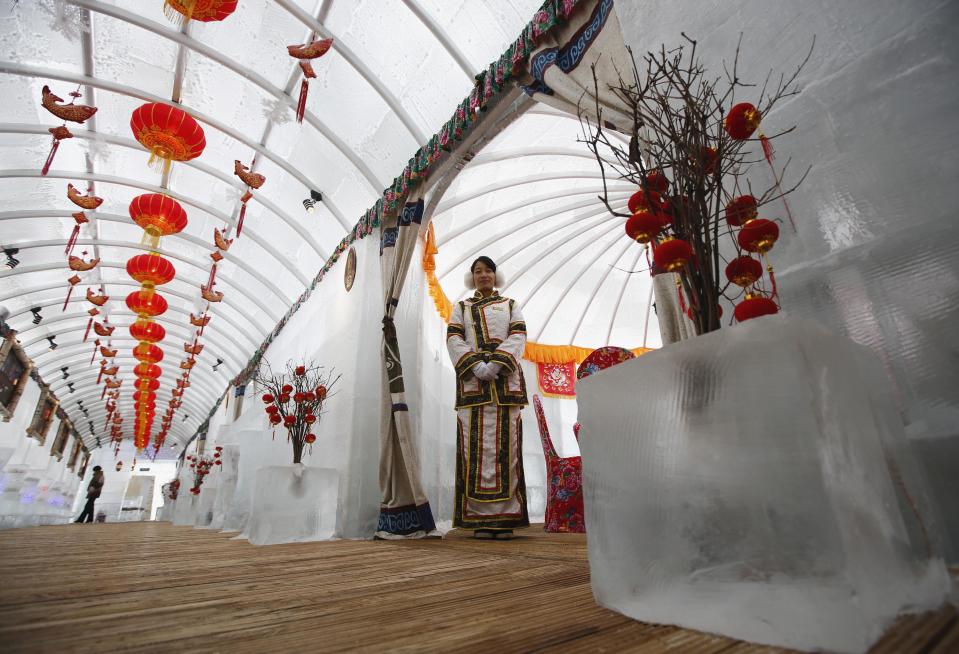 A waitress poses during a photo opportunity at the Ice Palace in Shangri-La Hotel in Harbin