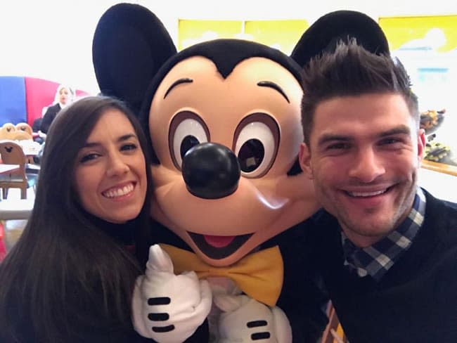 janette and aljaz smile and pose with a lifesize micky mouse