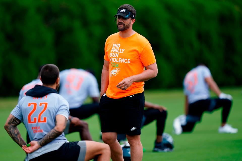 Philadelphia Eagles head coach Nick Sirianni meets with players as the warms up at the NFL football team's practice facility in Philadelphia, Friday, June 3, 2022.