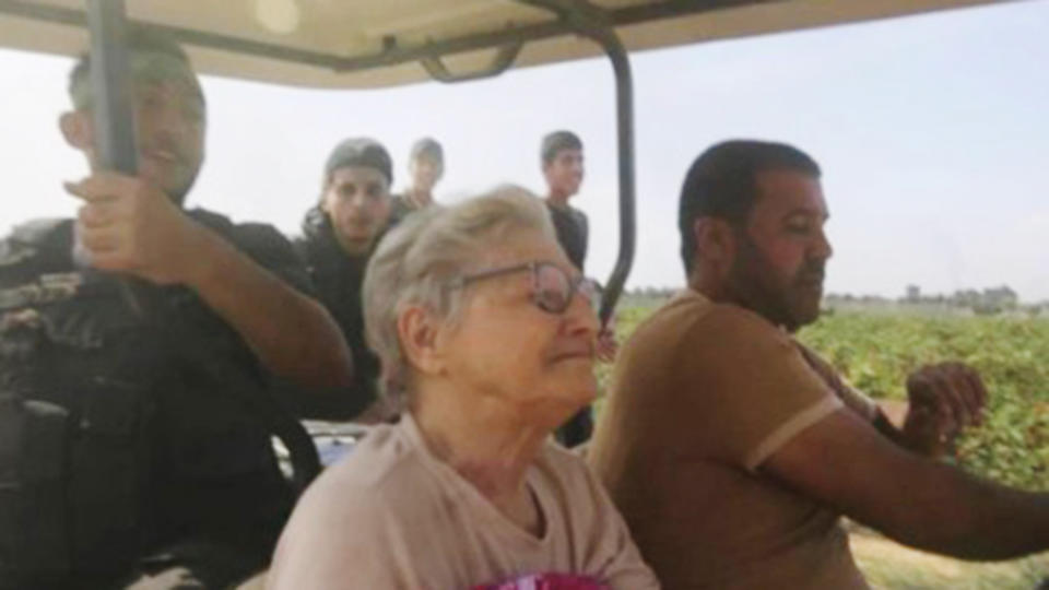 A still from a video showing 85-year-old Yaffa Adar being transported in a golf cart by armed men