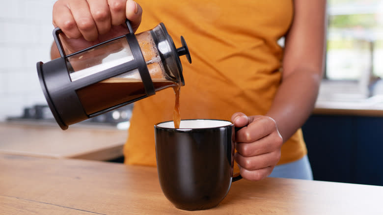 Person pouring coffee from French press