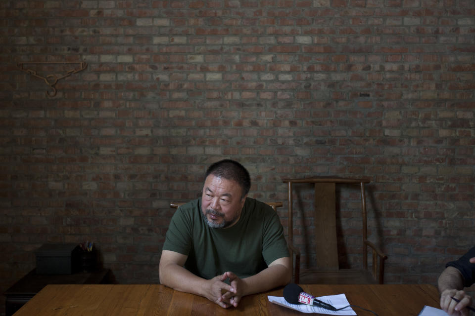 Artist Ai Weiwei speaks to journalists at his studio in Beijing, China, Wednesday, May 22, 2013. Ai's music video accompanying his heavy metal single “Dumbass’’ released Wednesday depicts an insensitive, overbearing state power that tramples on individual rights. The video is meant to reconstruct his 81-day secret detention in 2011, which was part of the overall crackdown by Chinese authorities on dissent. Ai later was convicted of tax evasion, which his supporters saw as punishment for his activism.(AP Photo/Alexander F. Yuan)