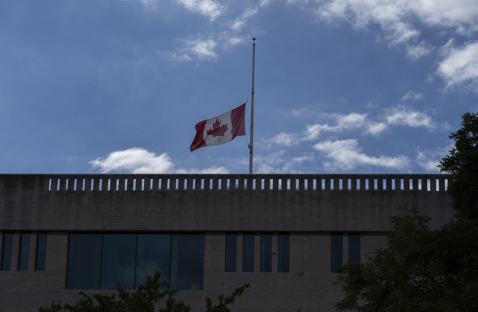 The Canadian flag flies at half-staff over the Canadian Embassy in Washington, Thursday, Sept. 8, 2022, after Queen Elizabeth II, Britain's longest-reigning monarch and a rock of stability across much of a turbulent century, died Thursday after 70 years on the throne. She was 96. (AP Photo/Gemunu Amarasinghe)