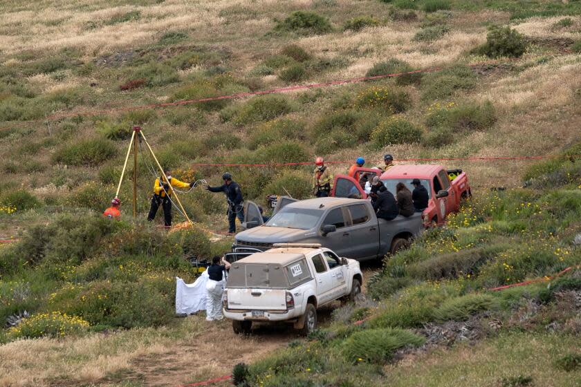 TOPSHOT - Rescue workers, forensics, and prosecutors work in a waterhole where human remains were found near La Bocana Beach, Santo Tomas delegation, in Ensenada, Baja California State, Mexico, on May 3, 2024. . The FBI said on Friday that three bodies were found in Mexico's Baja California, near an area where two Australians and an American went missing last week during a surfing trip. "We confirm there were three individuals found deceased in Santo Tomas, Baja California," a statement from the FBI's office in San Diego said without providing identities of the victims. (Photo by Guillermo Arias / AFP) (Photo by GUILLERMO ARIAS/AFP via Getty Images)