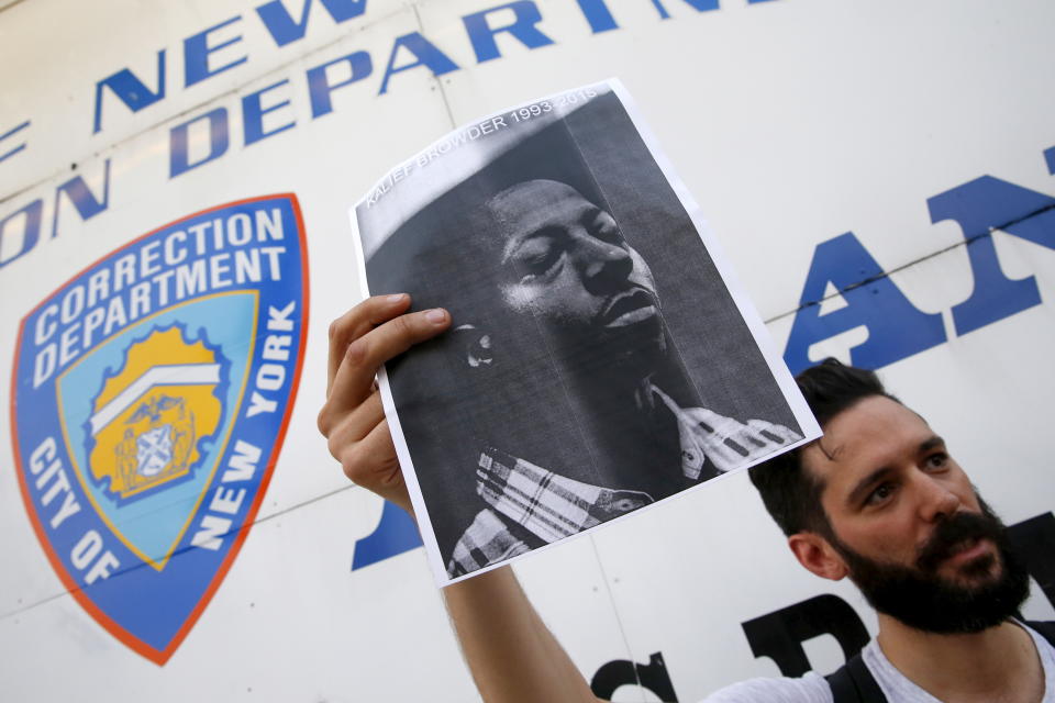 A demonstrator holds a photo of Kalief Browder during a candlelight vigil outside the entrance to the Rikers Island correctional facility in the Queens borough of New York June 11, 2015. New York City Mayor Bill de Blasio on Monday vowed to push reforms at the city's troubled Rikers Island prison complex after the reported weekend suicide of the 22-year-old Browder who had been held there for three years without being convicted of a crime. REUTERS/Shannon Stapleton