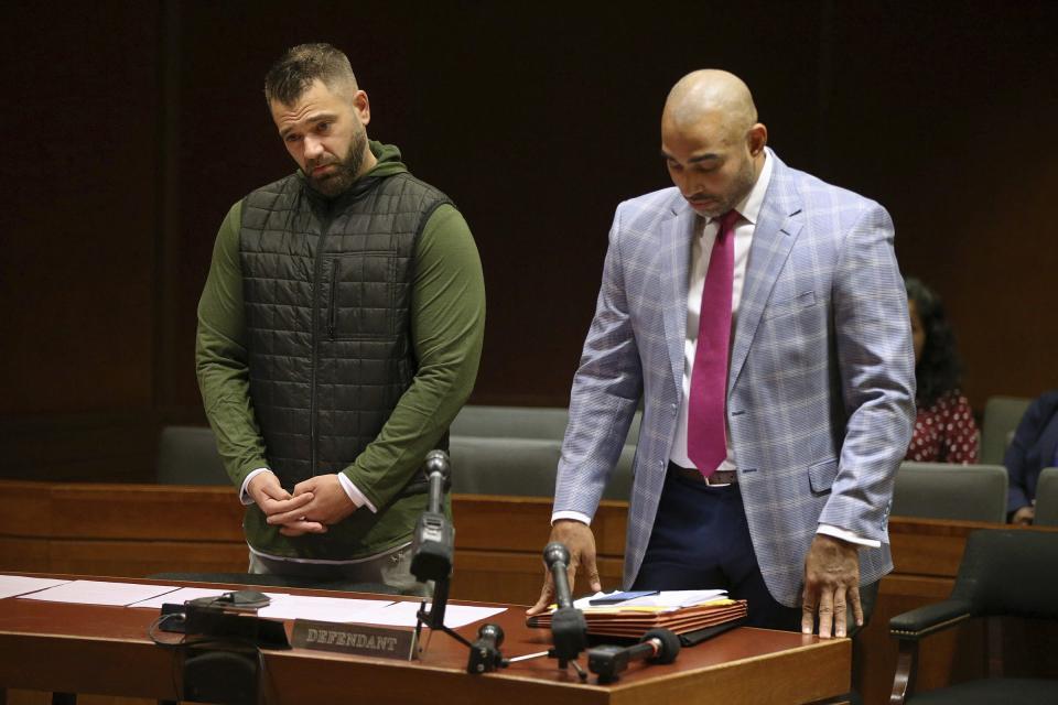 Mark D'Amico, left, stands with his lawyer, Mark Davis, as he pleads guilty to one count of misappropriating entrusted funds in Burlington County Superior Court in Mount Holly, N.J., on Friday, Dec. 6, 2019. Along with his then-girlfriend, Kate McClure, and a homeless man, Johnny Bobbitt, D'Amico allegedly set up a false online fundraiser and kept the money for themselves. (Tim Tai/The Philadelphia Inquirer via AP)