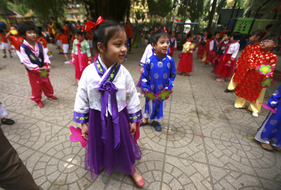 In this Thursday, Feb. 21, 2019, photo, children in Vietnamese and Korean traditional costumes dance at Vietnam-Korea Friendship Kindergarten in Hanoi, Vietnam. The children have been practicing singing and dancing, hoping to show off their talents to North Korean leader Kim Jong Un when he comes to town this week for his second summit meeting with U.S. President Donald Trump. (AP Photo/Hau Dinh)