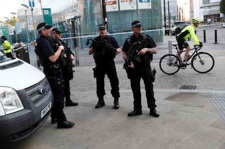 Armed police stand near the Manchester Arena in Manchester, Britain May 25, 2017. REUTERS/Stefan Wermuth